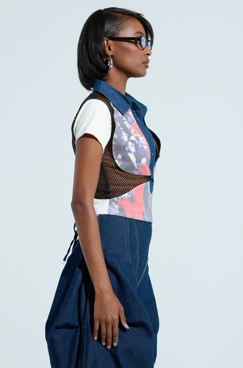 A person with short hair wearing sunglasses, the Edgy Diva Short Sleeve Netted T-shirt layered beneath a fishnet mesh vest, and high-waisted denim trousers stands in profile against a plain background.