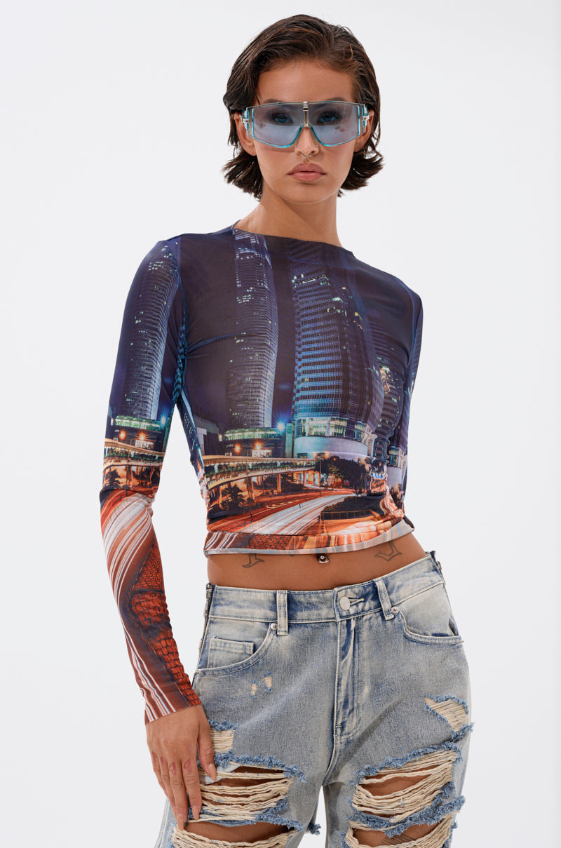 A person with short dark hair wears blue tinted sunglasses, distressed light-wash jeans, and the CITY LOVER MESH LONG SLEEVE, posing against a plain white background for an urban-chic vibe. 1