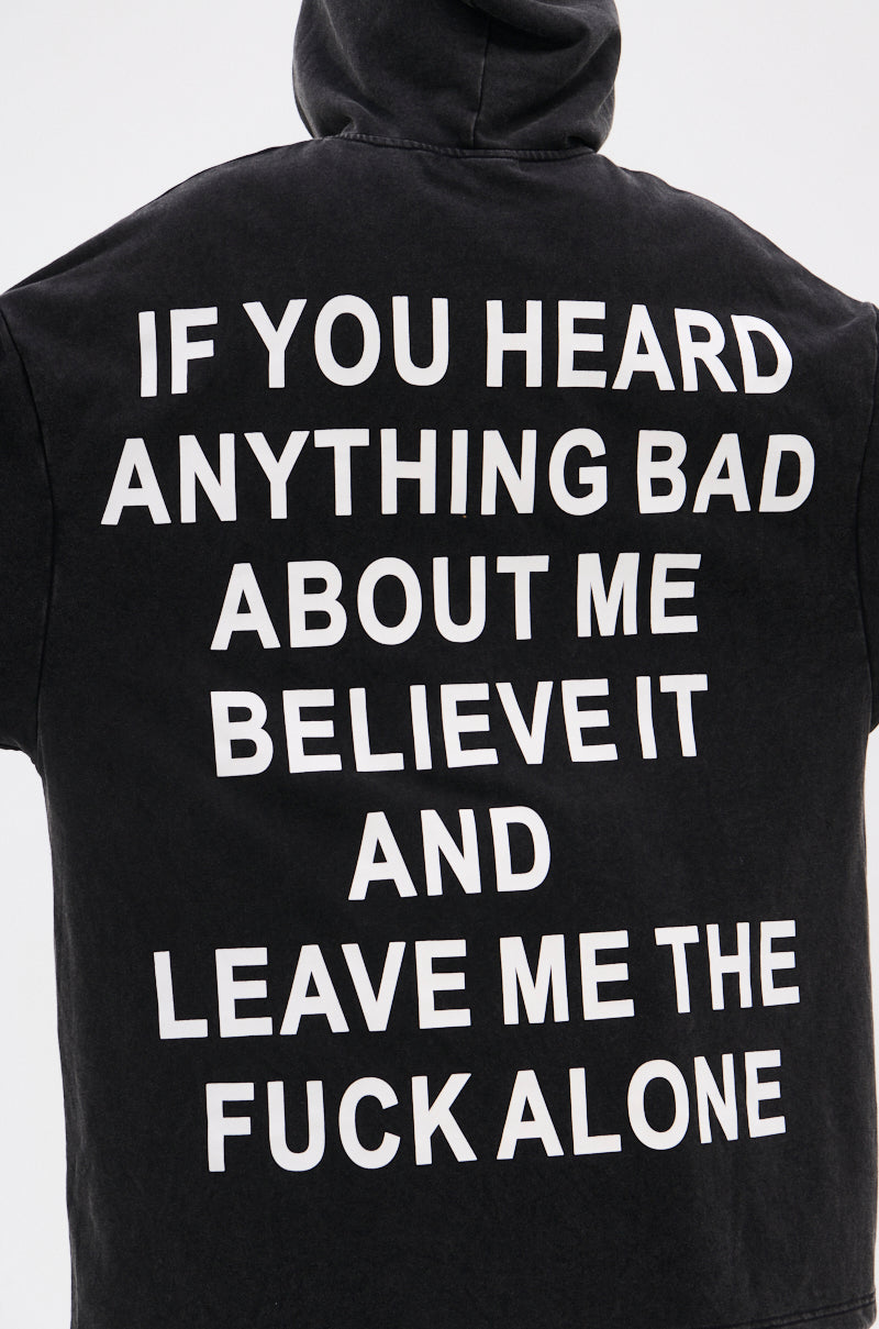 Someone sports the BELIEVE WHAT YOU HEARD OVERSIZED ZIP UP SWEATSHIRT, featuring a relaxed fit and bold white text: "IF YOU HEARD ANYTHING BAD ABOUT ME BELIEVE IT AND LEAVE ME THE FUCK ALONE. 13