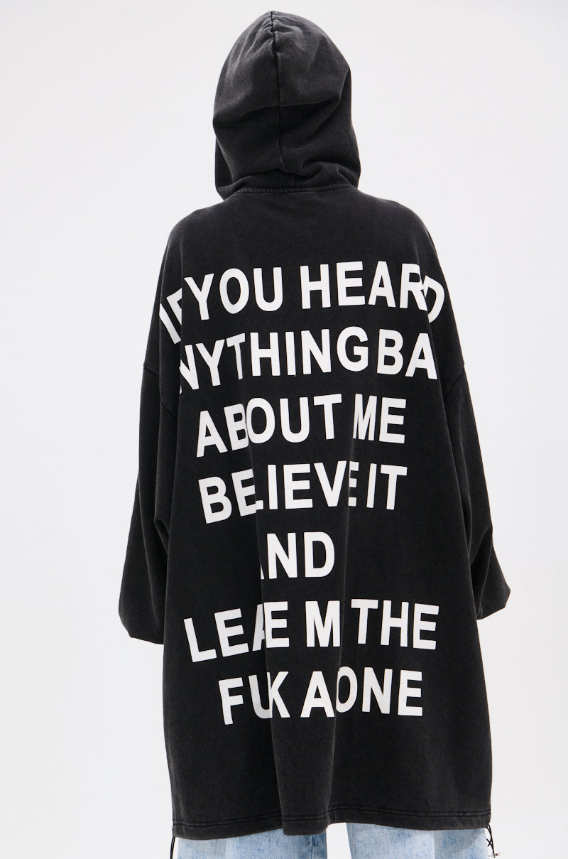 Someone is seen from behind wearing the BELIEVE WHAT YOU HEARD OVERSIZED ZIP UP SWEATSHIRT, featuring a relaxed fit and bold white text: "IF YOU HEARD ANYTHING BAD ABOUT ME BELIEVE IT AND LEAVE ME THE FUK AONE. 8