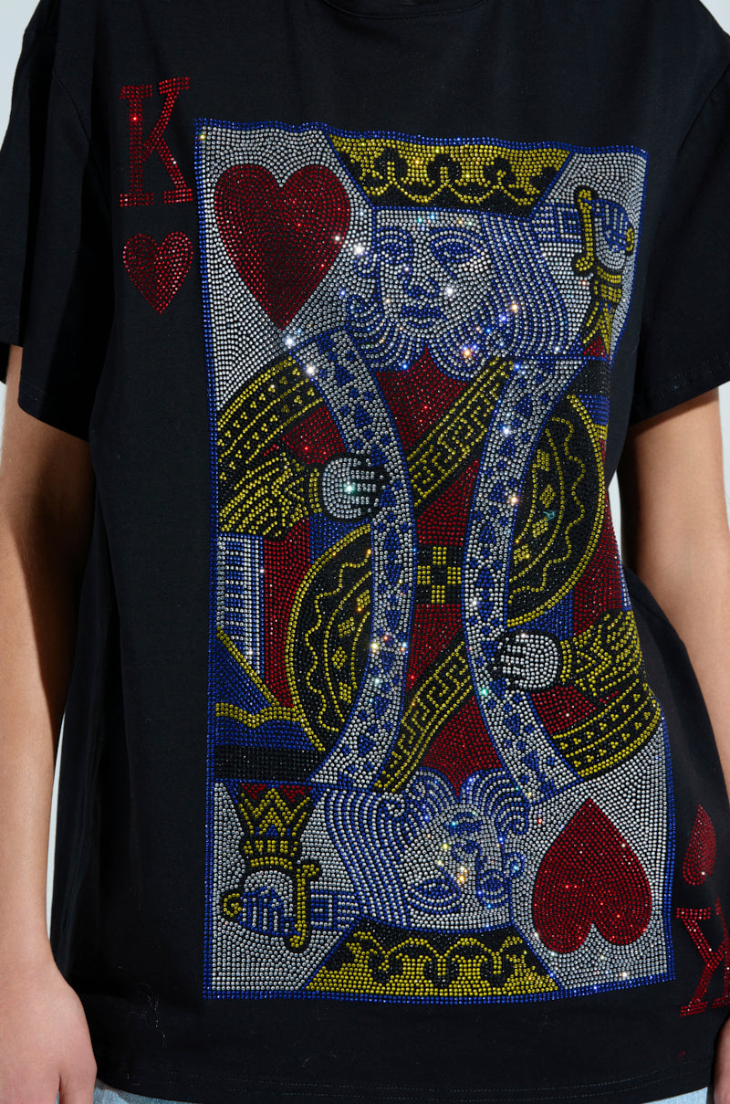 A close-up of the KING OF HEARTS OVERSIZED TEE displays a rhinestone graphic of the King of Hearts card, enhanced with glittering red, blue, yellow, and silver accents.