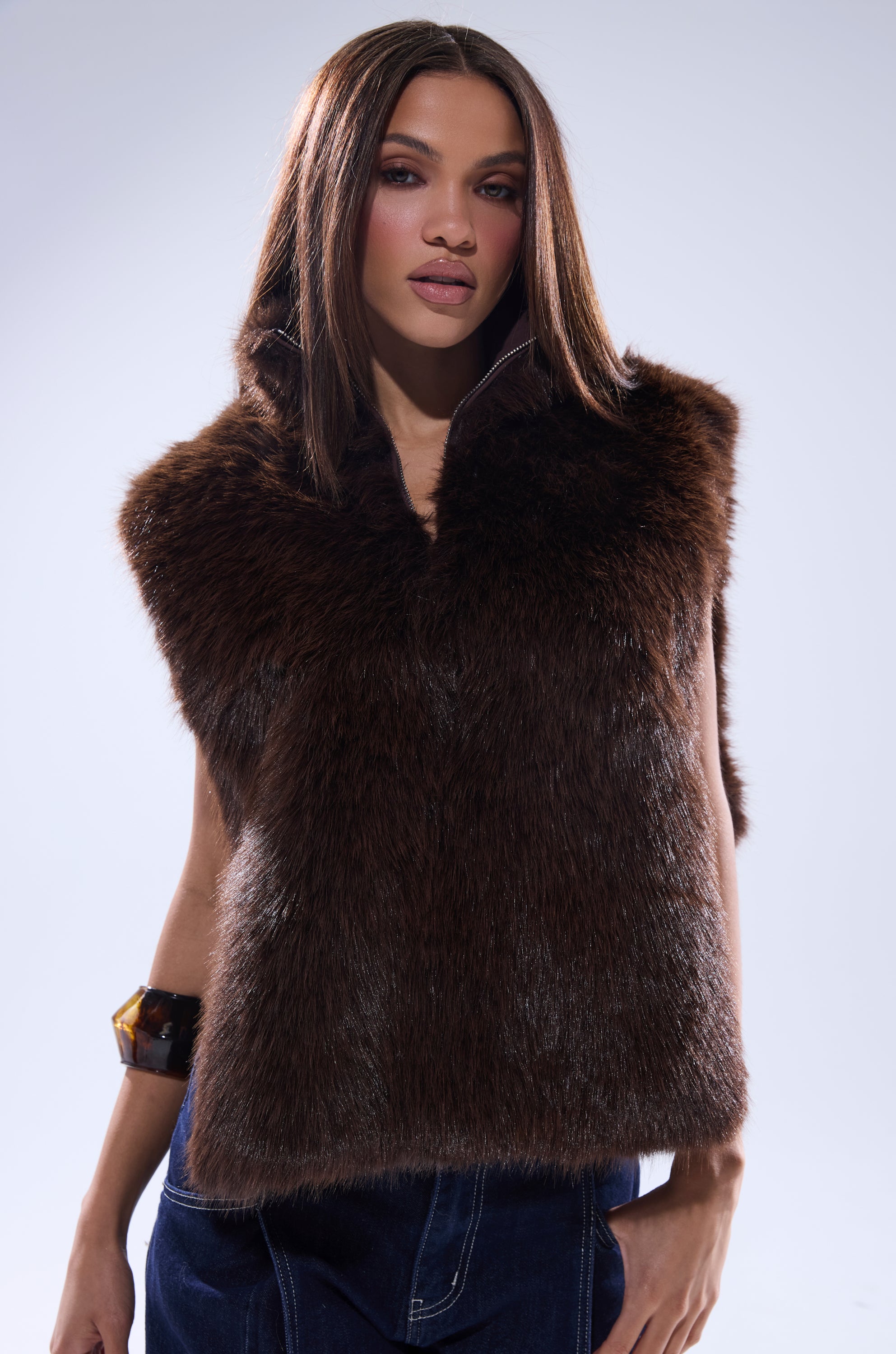 A woman with straight brown hair wears the SURE THANG FUR TURTLENECK PULLOVER in dark brown and dark blue pants, standing against a plain light background and looking confidently at the camera. 0