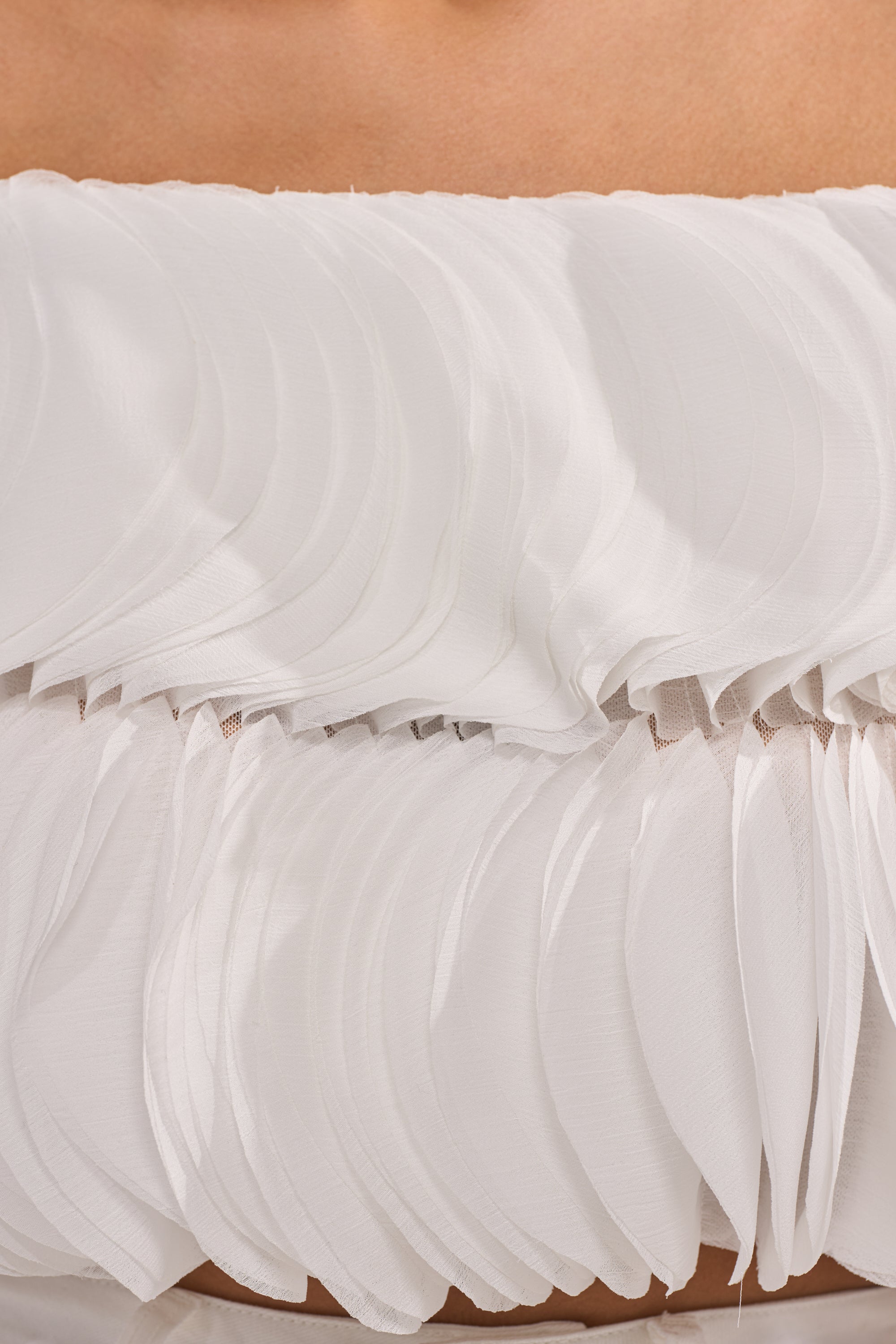 Close-up of the DAYDREAMER CHIFFON BLOUSE, a high-fashion strapless top with layered petal design for textured, ruffled details against the skin. 7