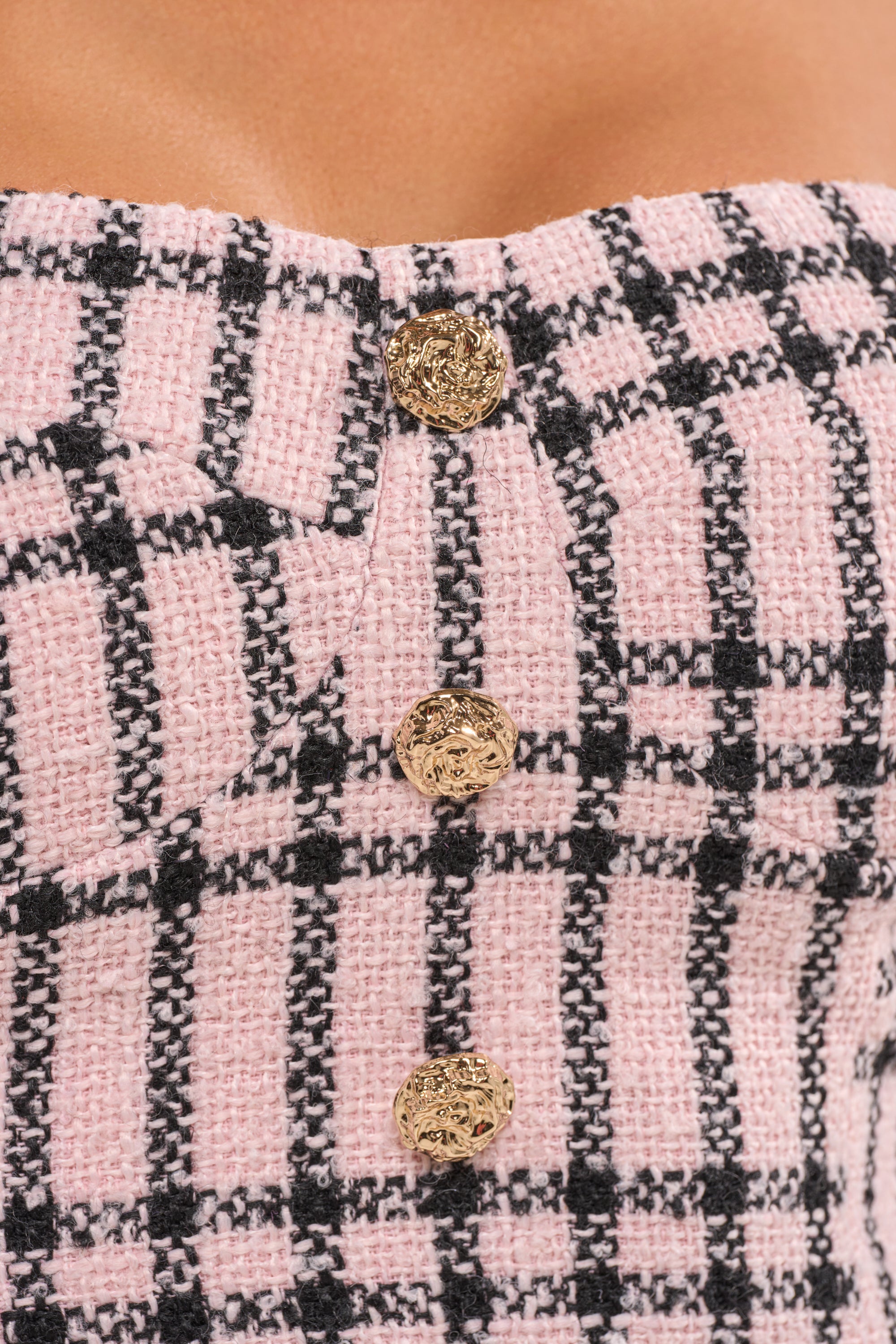 Close-up of the LOOK AT ME BABY TWEED CORSET, featuring textured pink plaid tweed and three ornate gold buttons down the front on a strapless design. 6