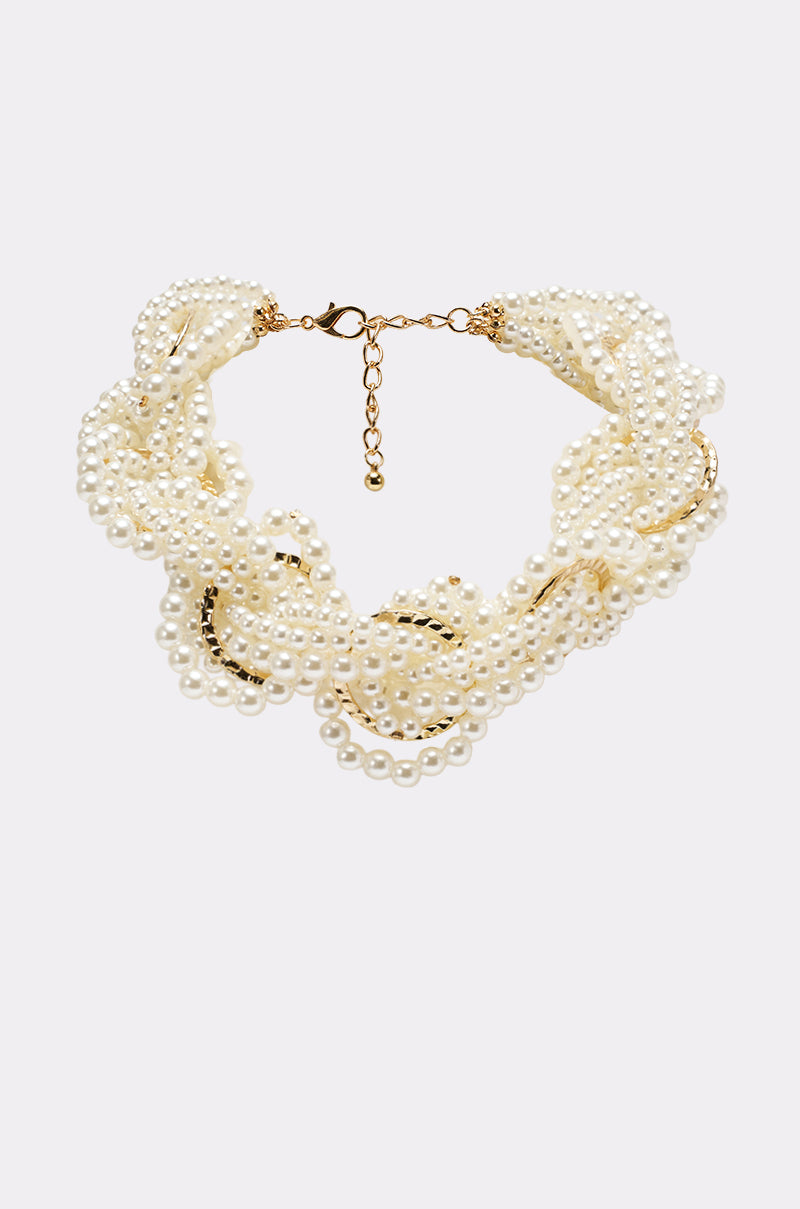 The SHARON NECKLACE is a multi-strand, twisted design featuring lustrous white faux pearls, gold-tone accents, and an adjustable clasp closure. 0