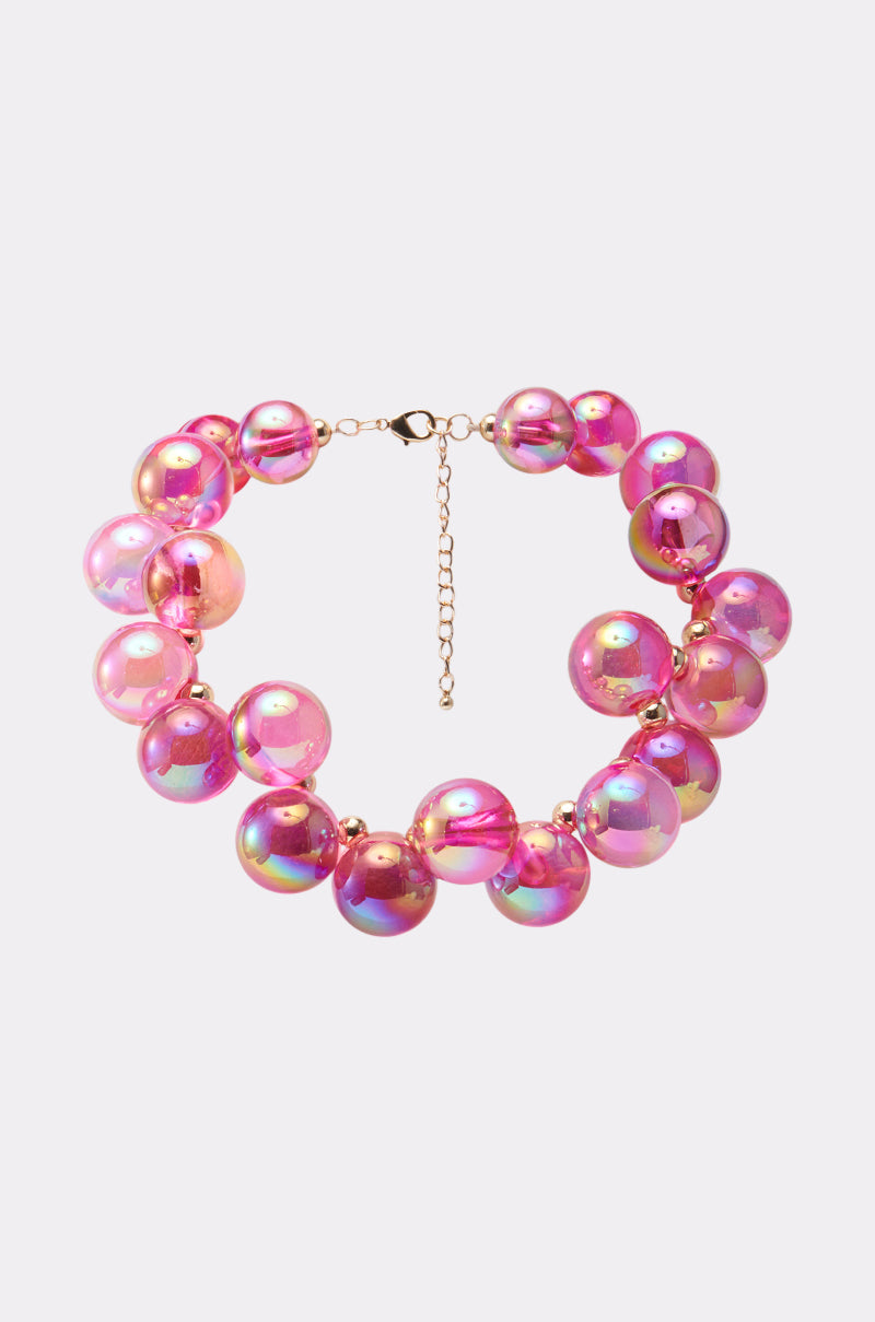 The POP BUBBLY NECKLACE is a chunky choker with large iridescent pink beads and an adjustable lobster clasp, shown on a light background.