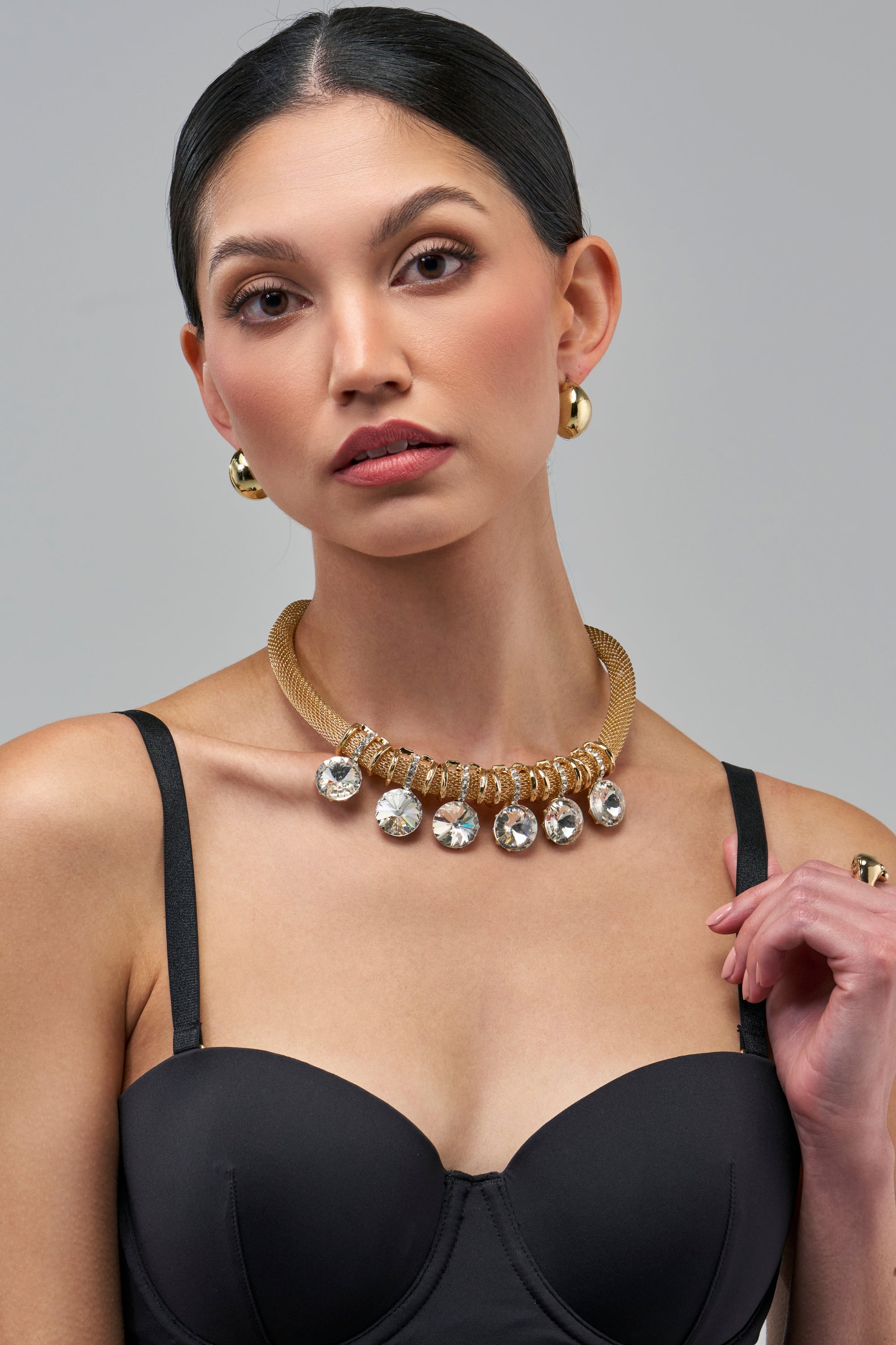 NOTHING SUBTLE NECKLACE featuring a gold-toned mesh chain with a row of large, circular clear crystal charms.