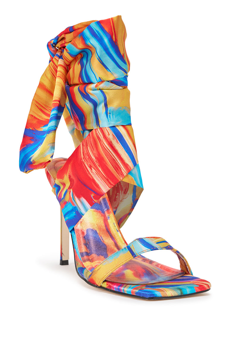 The AZALEA WANG JOHA ORANGE MULTI PRINTED SATIN WRAP UP STILETTO is a vibrant high heel sandal with a colorful marble pattern, wraparound satin straps that tie above the heel, and a single strap across the open square toe. 4