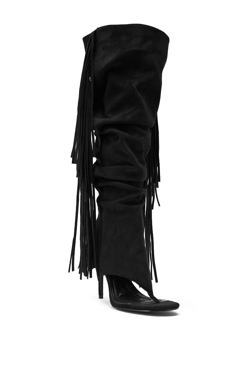 The AZALEA WANG JOHANNA BLACK FRINGE GLADIATOR SANDAL is a knee-high, black faux suede sandal featuring high stiletto heels, an open toe, and long fringe detailing down the sides. 5