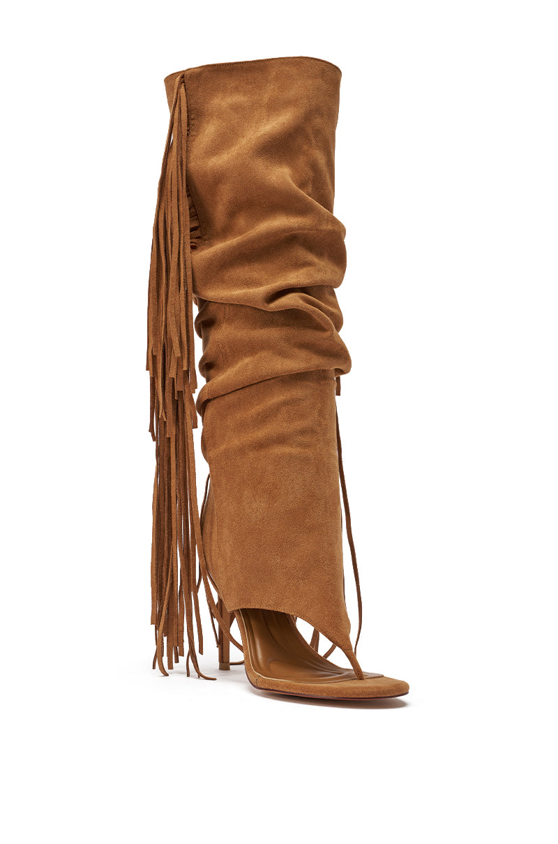 The AZALEA WANG JOHANNA TAN FRINGE GLADIATOR SANDAL features a knee-high slouchy shaft, open toe, stiletto heel, side fringe detail, and smooth faux suede with a modern asymmetric cut. 3