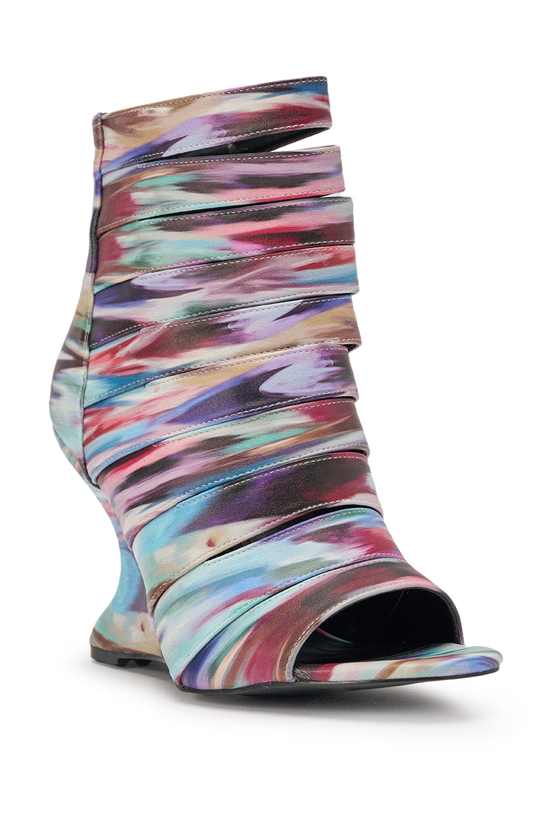 The AZALEA WANG JOHANNES MULTI RAINBOW WEDGE OPEN TOE BOOTIE features a high wedge heel, sculpted silhouette, and layered abstract bands in purple, blue, pink, and beige for a bold, modern look. 4