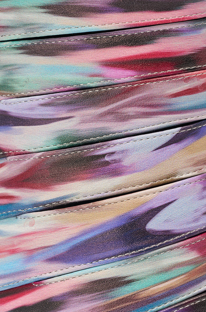 Close-up of the AZALEA WANG JOHANNES MULTI RAINBOW WEDGE OPEN TOE BOOTIE’s fabric, showcasing diagonal seams and a vibrant abstract pattern with painted swirls of pink, purple, blue, and green. 6