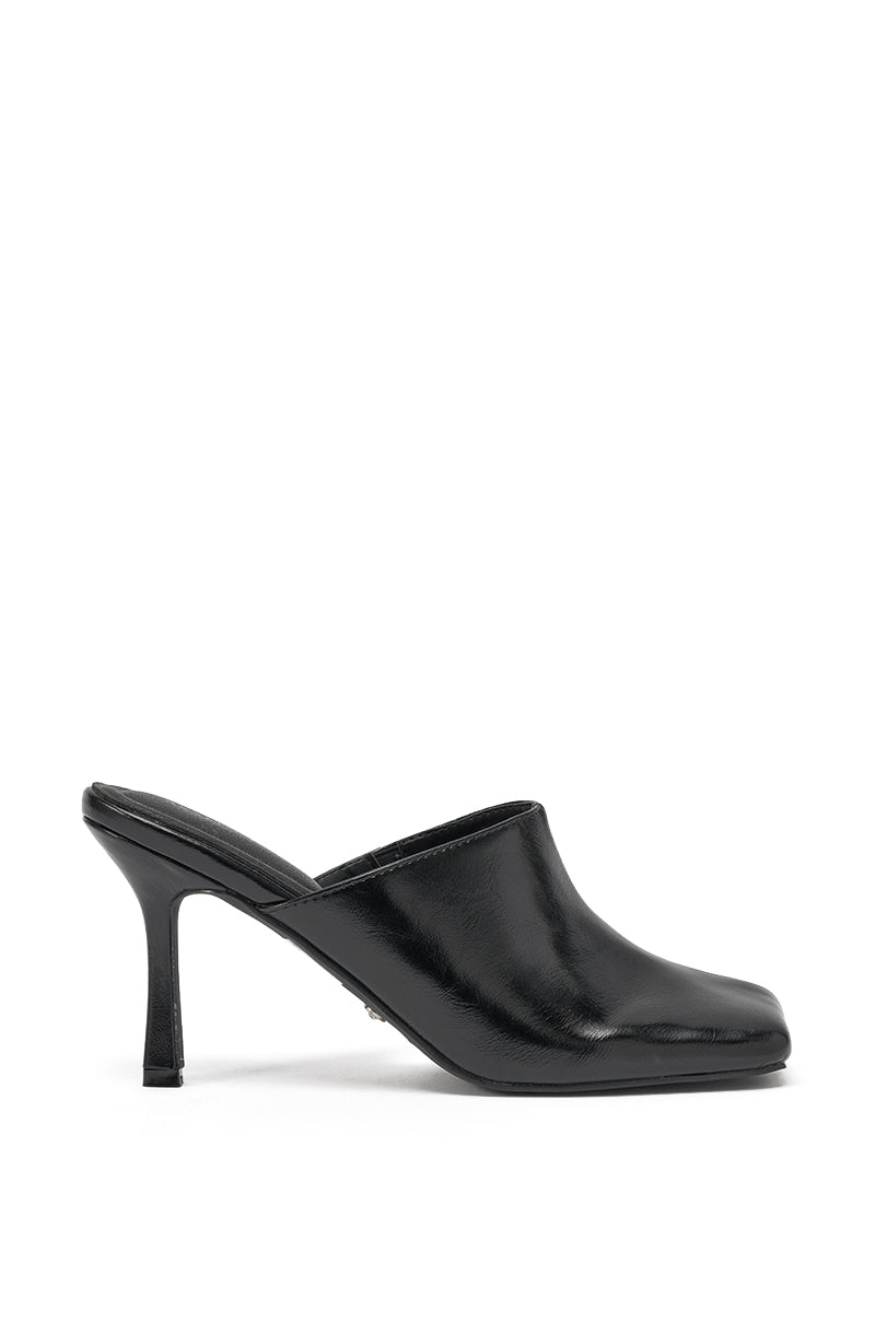The AZALEA WANG JONENE BLACK STILETTO MULE features a black faux leather build, square toe, closed upper, and stiletto heel, shown in side profile on a plain white background. 3