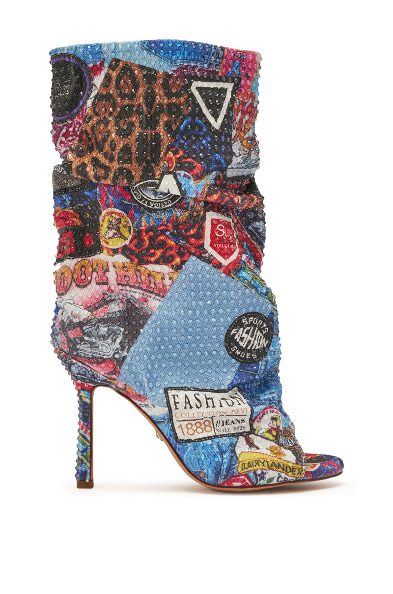 The AZALEA WANG JONICE BLUE MULTI RHINESTONE OPEN TOE BOOTIE is a high-heeled denim bootie with colorful patchwork, leopard print patterns, and eye-catching fashion-inspired rhinestone embellishments. 2