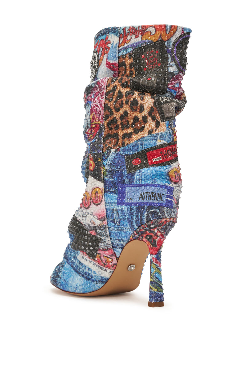 The AZALEA WANG JONICE BLUE MULTI RHINESTONE OPEN TOE BOOTIE is a high-heeled stiletto featuring a slouchy design with animal prints, denim patterns, colorful graphics, rhinestones, and bold labels like "AUTHENTIC. 4