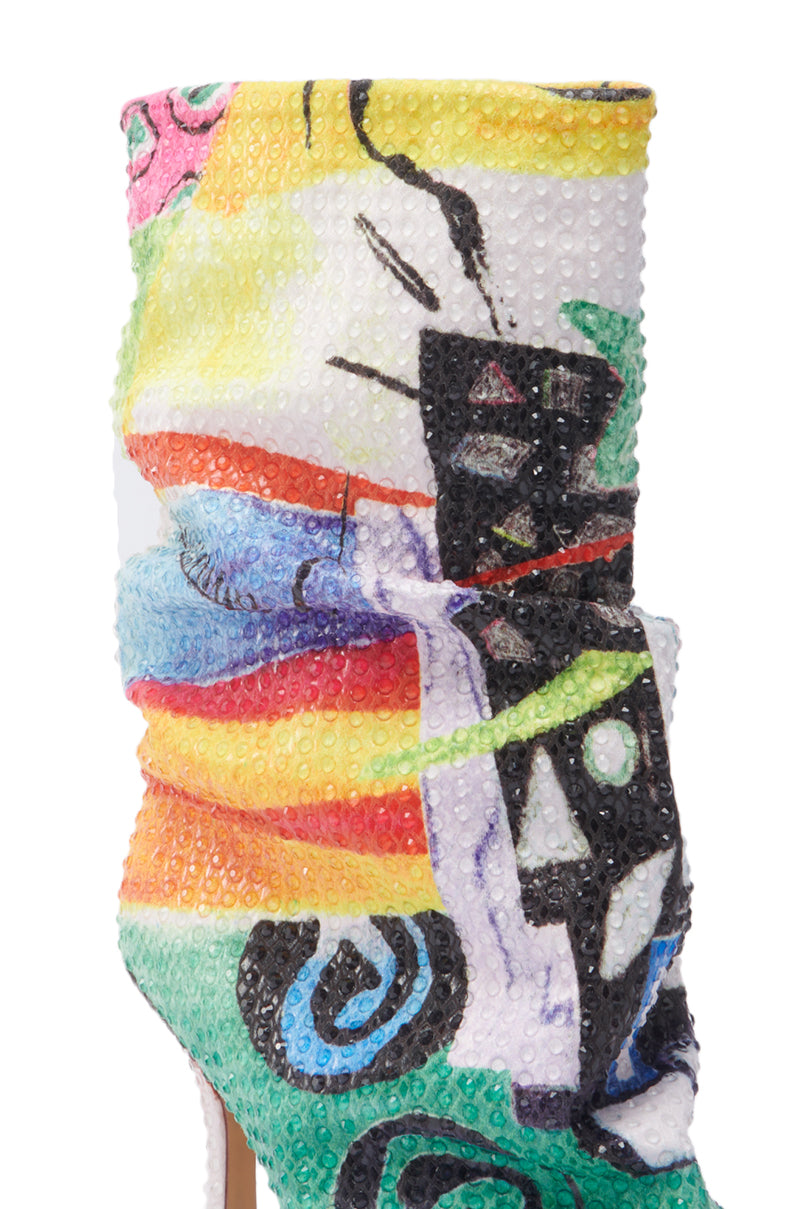 A close-up of the AZALEA WANG JONICE MULTI OPEN TOE BOOTIE, featuring a stiletto heel and a bold, colorful abstract pattern with a textured, bubble-like surface for a vibrant statement look.