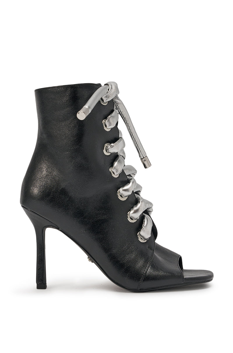 The AZALEA WANG JOSS BLACK BLOCK LACE OPEN TOE BOOTIE features black faux leather, an open toe, bold oversized silver laces through large front eyelets, and a modern block heel for standout style. 3