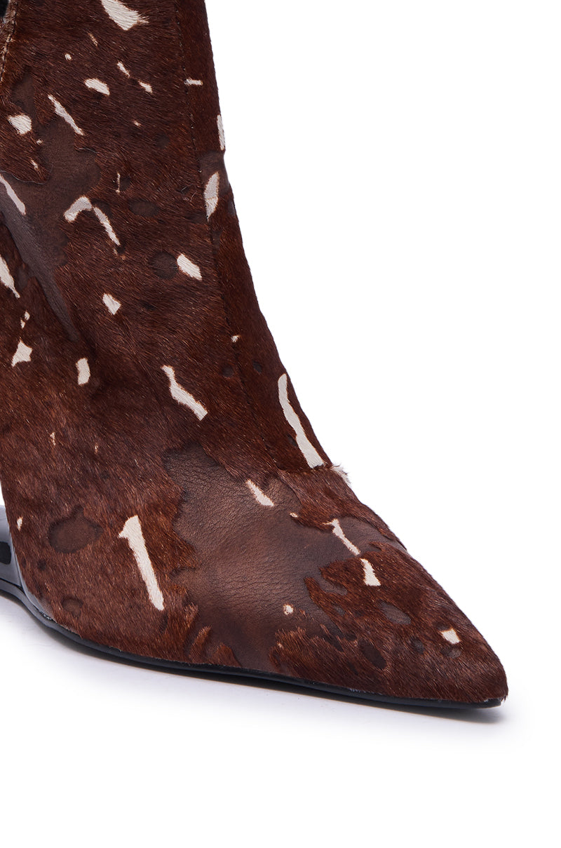 Close-up of the AZALEA WANG JOST BROWN MULTI WEDGE PUMP featuring a pointed toe slingback design in brown and white cowhide leather with a natural spotted pattern, fine hair texture, and sleek side stitching.