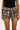 A person is wearing a black top and the HIT THE ROAD CHEETAH SHORT from the AKIRA Label. These high rise waisted shorts are designed with multiple layers of cheetah pattern fabric, offering a voluminous and textured look. The upper portion of the person is not visible in the image.