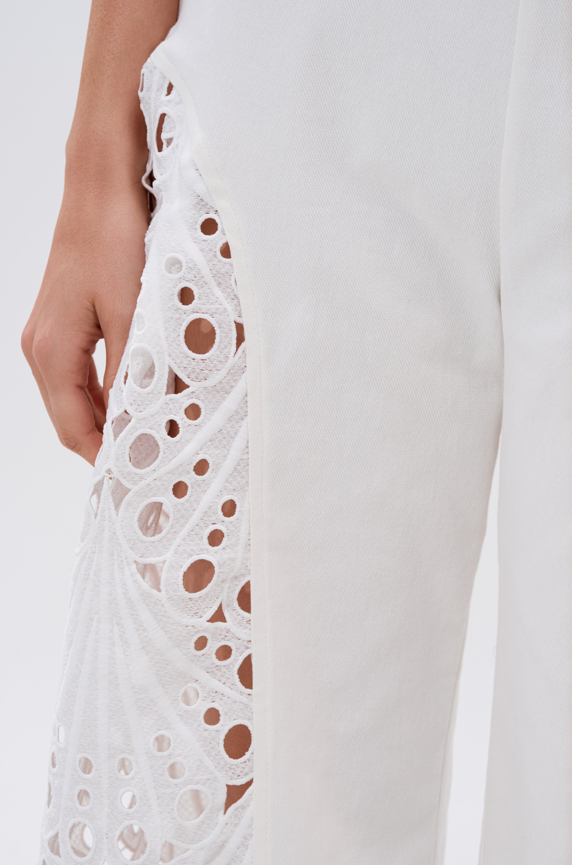 A close-up of the EASY BREEZY DENIM JUMPSUIT IN WHITE, highlighting its crisp denim fabric and modern silhouette. 5