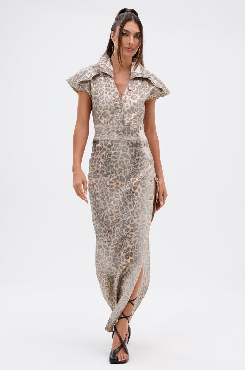 A woman walks forward in black strappy heels, wearing the TOO BUSY TO CARE LEOPARD MIDI DRESS—featuring a curve-hugging fit, wide collar, and short sleeves—against a plain white background.