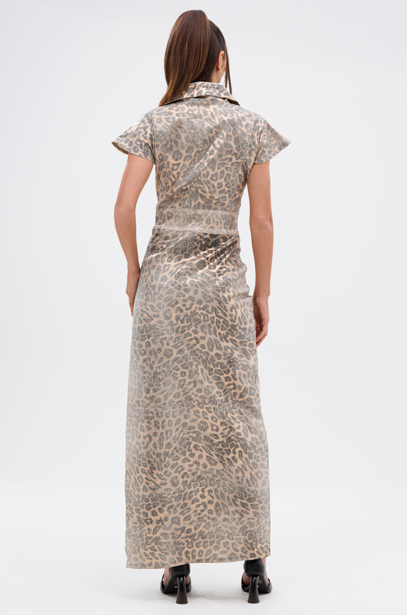 A woman with long brown hair in a ponytail wears the TOO BUSY TO CARE LEOPARD MIDI DRESS and black open-toe heels, standing with her back to the camera against a plain white background.