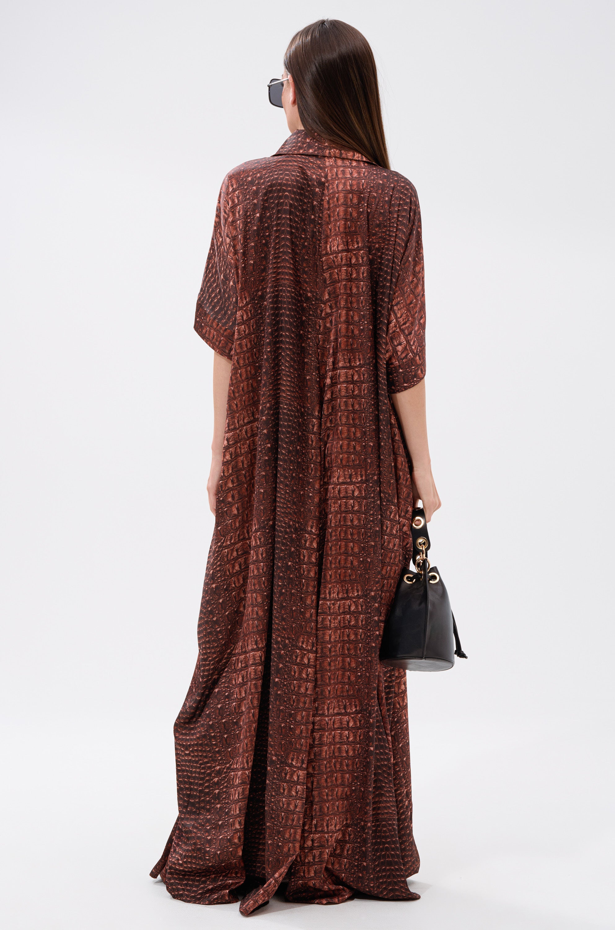 A woman stands confidently in the SHE'S RICH Oversized Satin Jumpsuit in Croc Print, exuding effortless style.