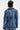 A person with short black hair is shown from the back wearing the MY OWN THING STUDDED DENIM BLAZER, featuring vertical lines of silver studs along the seams and a notched lapel collar against a light background.