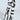 A person wears the GROOVE ON FAUX LEATHER FLARE TROUSER, featuring a black and white swirl pattern. They pair it with black pointed shoes adorned with silver studs. The flared leg silhouette enhances the dramatic, artistic design, while lighting casts a shadow on the white background.