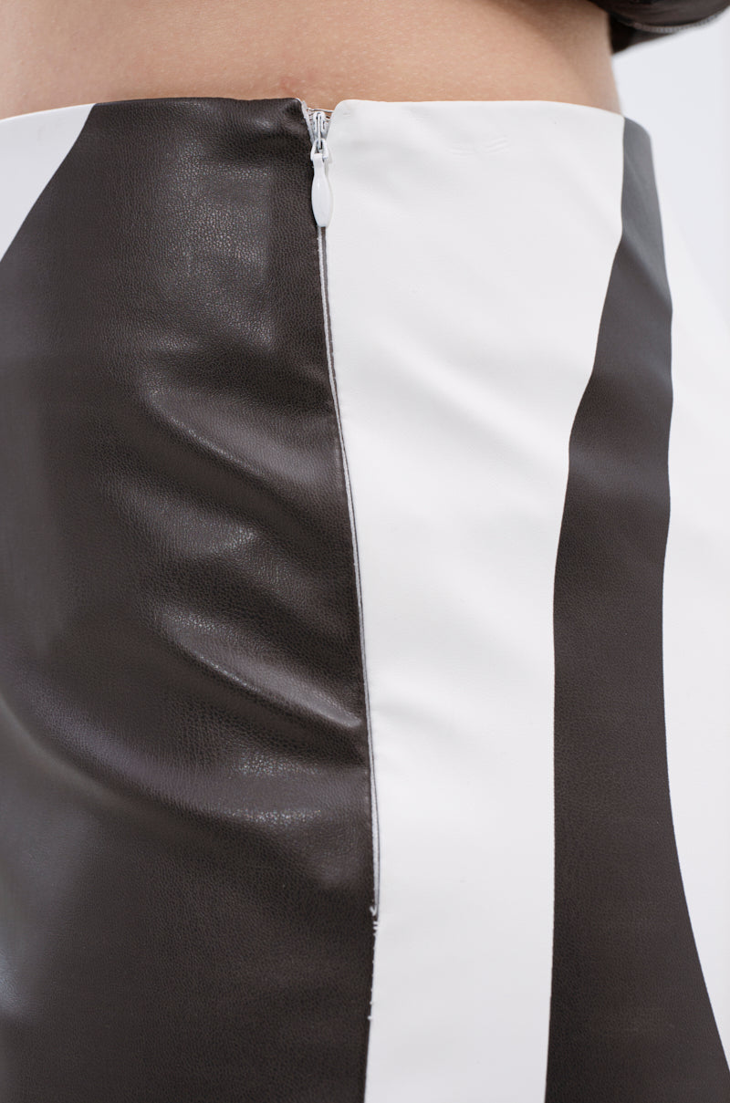 Close-up of a black and white color-blocked skirt with a side zipper, highlighting its texture and stitching—ideal for pairing with the GROOVE ON FAUX LEATHER FLARE TROUSER for a bold statement look.
