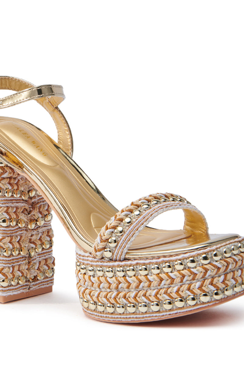 The AZALEA WANG JUDSON GOLD RAFFIA AND GEMS PLATFORM SANDAL features a chunky heel with a metallic gold ankle strap and is adorned with gold metallic studs on the edges, blending fabrics and textures in chic beige and gold tones.