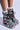 Meet the AZALEA WANG JULIEN BLUE MULTI CHUNKY BOOTIE: vibrant plaid boots with a textile upper in red, blue, and black stripes. Black laces provide contrast, especially when worn with white socks on a light gray background. Ideal for bold fashion statements!.