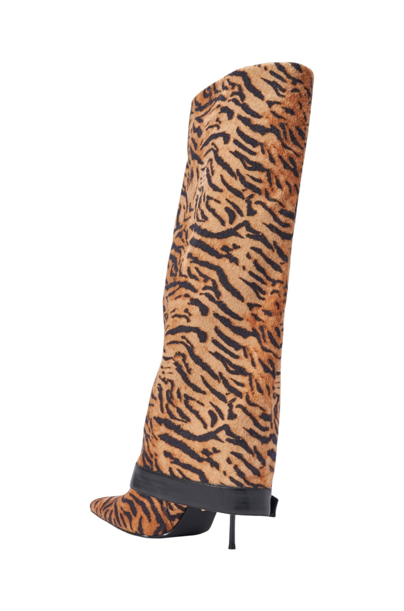 The AZALEA WANG JUST TIGER STILETTO FOLD OVER BOOT is a tall, slouchy stiletto with bold orange and black tiger stripes, a pointed toe, thin high heel, and black leather trim at the ankle. 6