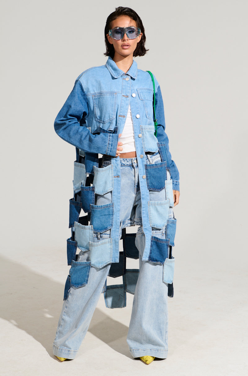 A person wearing a BRAXTON DENIM POCKET TRENCH, wide-leg jeans, a white top, sunglasses, and yellow shoes stands confidently against a plain background.
