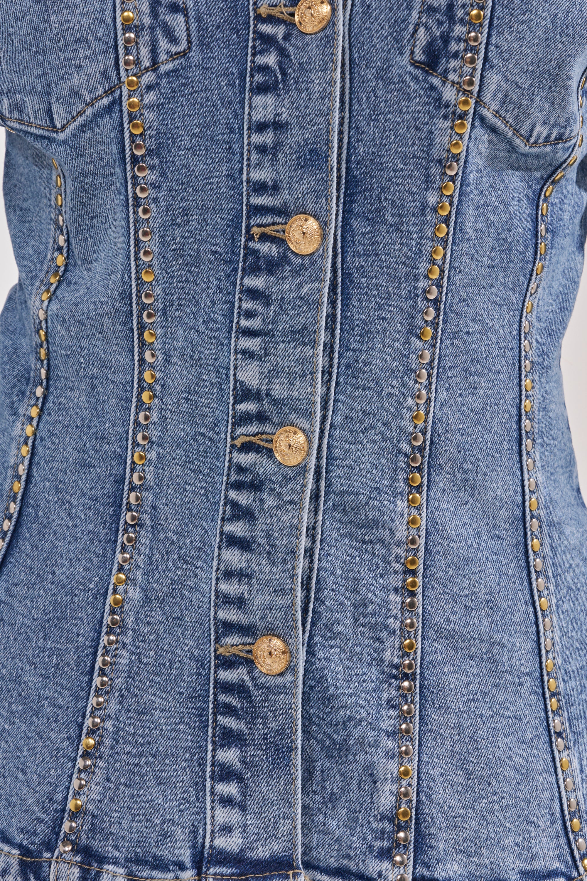 Close-up of the SHOULD'VE KNOWN BETTER STUDDED DENIM JACKET in blue denim, featuring gold-tone buttons down the center and decorative studs along vertical seams for a flattering, waist-defining fit. 6