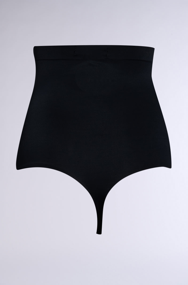 The TITSY SHAPER THONG IN BLACK features high-waisted shapewear panties with seamless hems and a thong bottom on a plain gray background, offering a high-rise fit perfect for body contouring.