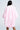 A person with long, straight black hair is seen from the back, wearing the FLOATING NYLON BUBBLE BOMBER IN LIGHT PINK, featuring a loose silhouette with billowy sleeves and a gathered hem, set against a plain light background.