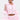 A person wears the ultra-kawaii CANDY LACE TRIM WINDBREAKER in light pink with sheer ruffled sleeves, white lace trim, and bow details. They have short dark hair, hoop earrings, a torso tattoo, and stand against a plain white background.