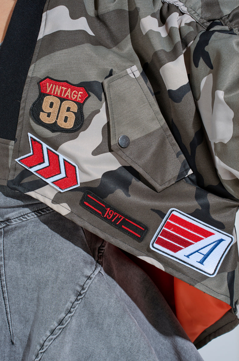 ON THE RUN CAMO SHRUG – AKIRA