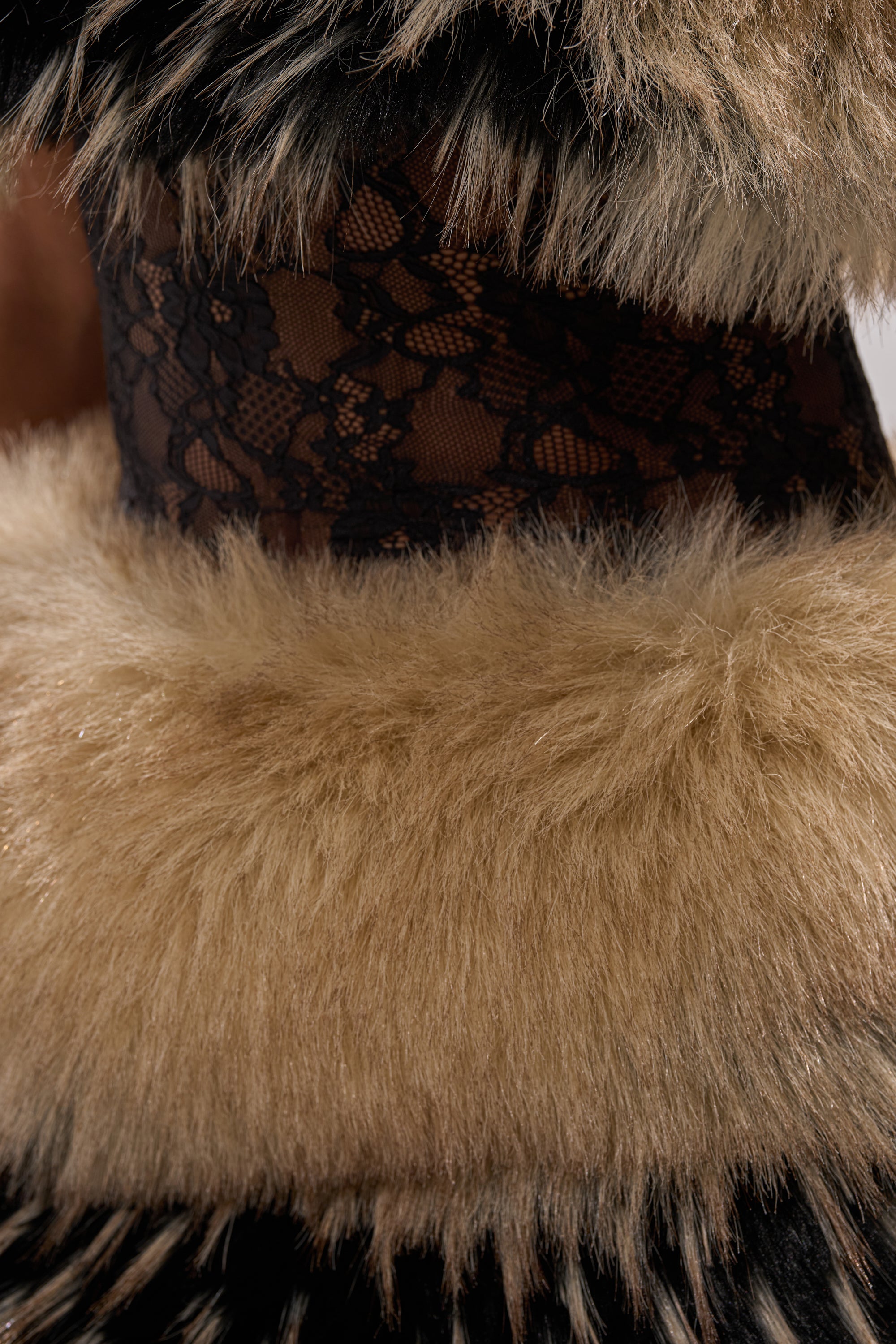 A close-up shows a person wearing the COOL GIRLS ONLY LACE FUR MINI DRESS, featuring lace fabric with fluffy, light brown faux fur trim and accents that create a bold texture contrast.