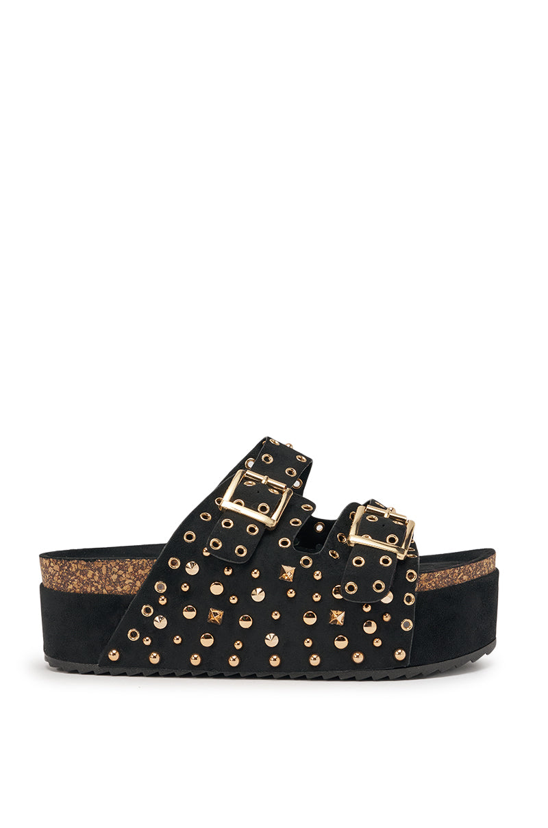 The AZALEA WANG KAEGAN BLACK FLATFORM STUD EMBELLISHED SLIP ON SANDAL features two wide black suede straps with gold studs and buckles atop a cork platform sole. 3