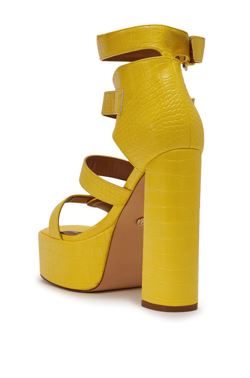 The AZALEA WANG KAELIN YELLOW CROC PU PLATFORM CHUNKY SANDAL features a high heel, croc-embossed faux leather, three foot straps, an ankle strap, and a chunky block platform. 5