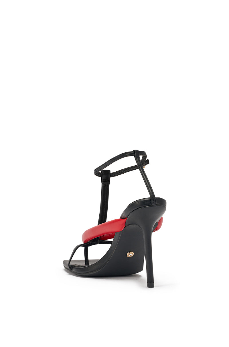 The AZALEA WANG KALIA RED MULTI PUFFY STRAP STILETTO SANDAL, featuring faux leather, a black puffy ankle strap, and a red band across the front, is shown against a white background from the back angle. 5