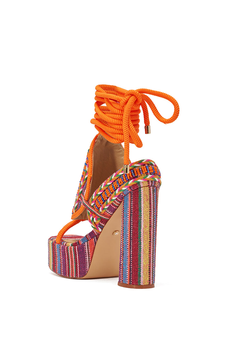 The AKIRA GOLD KALINA MULTI CHUNKY BEADED SANDAL features a vibrant boho design with multicolored stripes, bright orange wraparound ankle laces, and a thick block heel covered in matching striped fabric for a bold look. 6