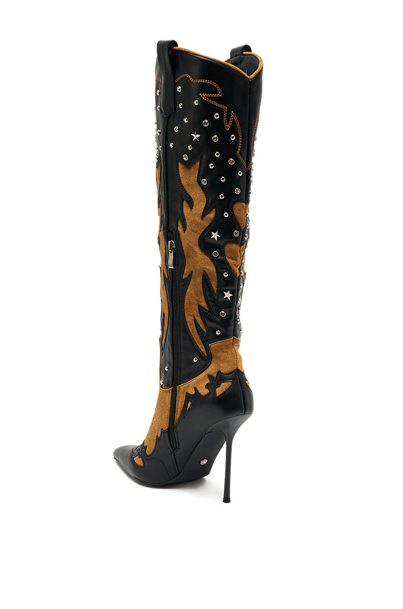 The AKIRA GOLD KALPANAS BLACK MULTI STILETTO WESTERN BOOT features thigh-high black leather, brown suede flame patterns, metal studs, star details, a pointed toe, and a side zipper for bold cowboy-inspired style.