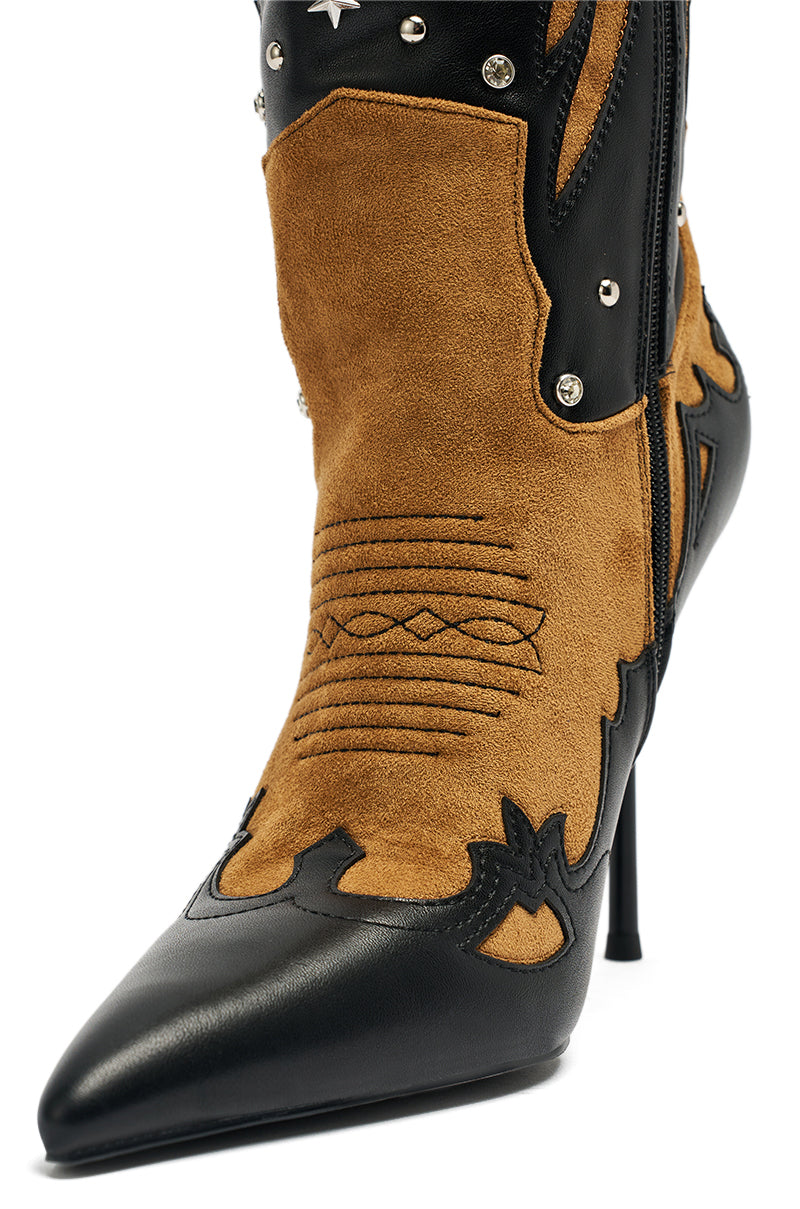 A close-up of the AKIRA GOLD KALPANAS BLACK MULTI STILETTO WESTERN BOOT, showcasing brown suede and black leather, western stitching, star and stud details, a pointed toe, and decorative patterns for a bold cowboy-inspired look.