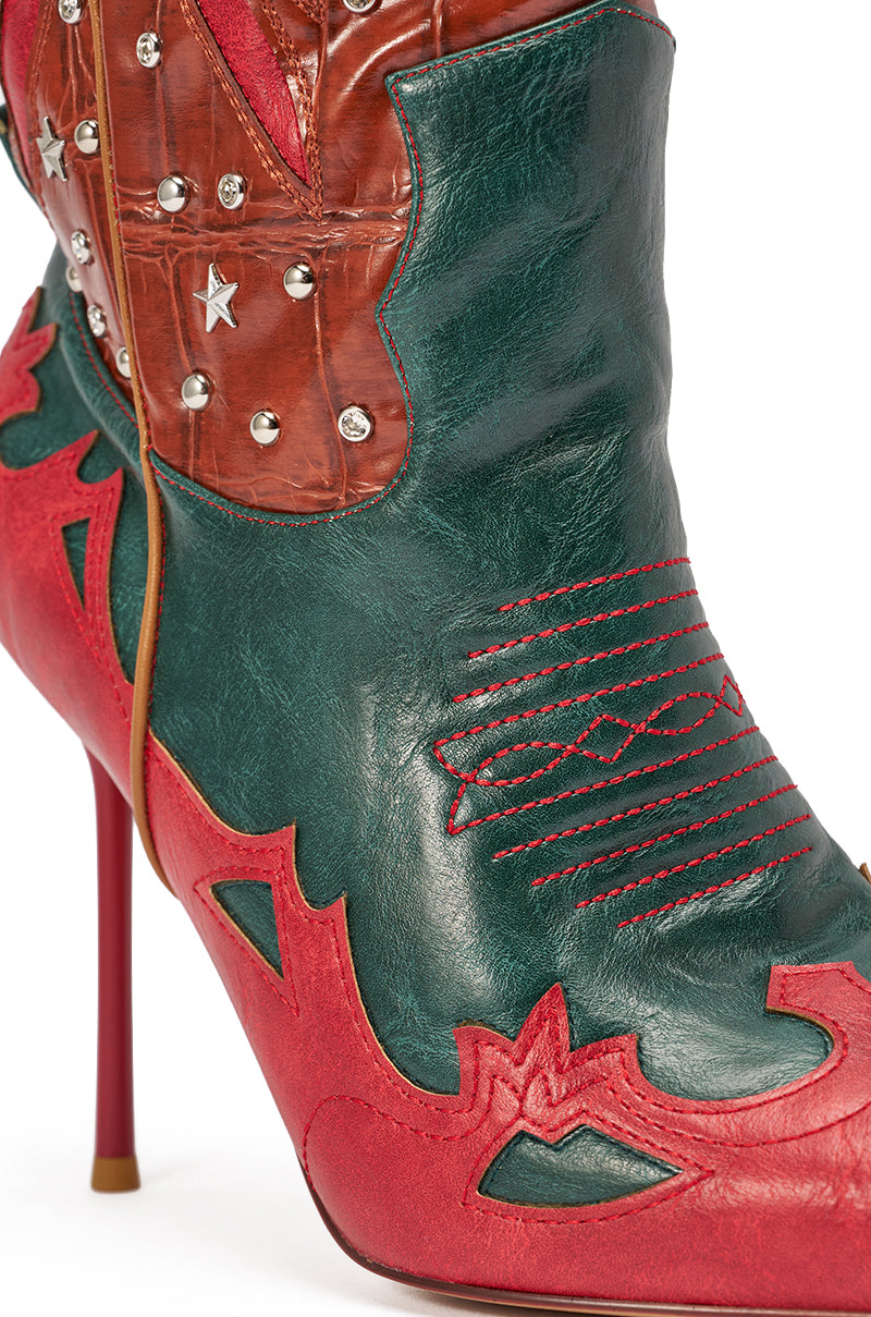 The AZALEA WANG KALPANAS MULTI WESTERN STILETTO BOOT is a knee-high, red stiletto boot with green, red, and brown leather, decorative stitching, metal studs, and a star embellishment. The heel is bright red. 6