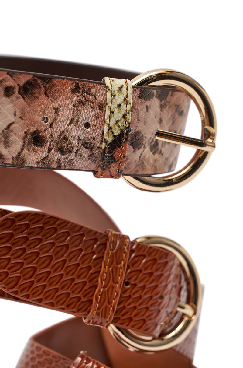 Close-up of two leather belts—one light brown snakeskin and one dark brown lizard-skin—intertwined, reflecting the elegance of the AKIRA GOLD KADINSKY COGNAC MULTI SNAKE MATERIAL STILETTO SANDAL. 7