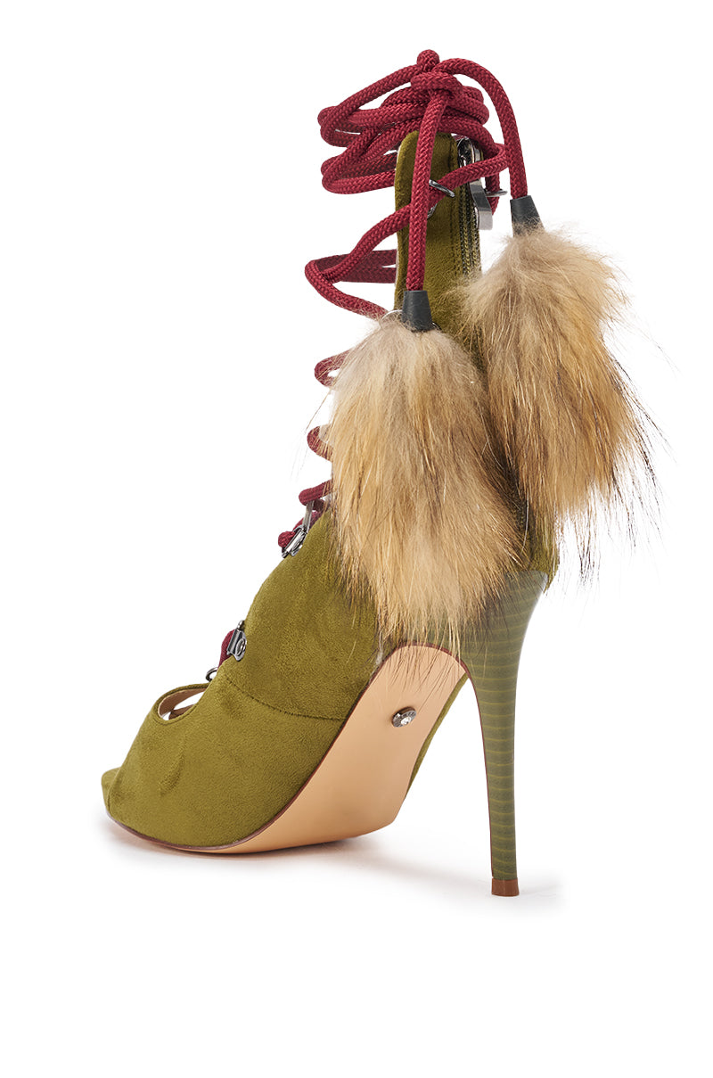The AZALEA WANG KARLA Olive Faux Suede Fur Embellished Stiletto Sandal features an open toe, stiletto heel, red lace-up straps with metal eyelets, and two brown faux fur pom-poms at the back. 6