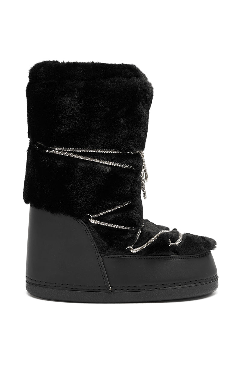 The AZALEA WANG KARMELA BLACK FUR MOON BOOT features a thick black faux fur upper, smooth lower section, and crisscrossing silver rhinestone laces decorating the front and sides.